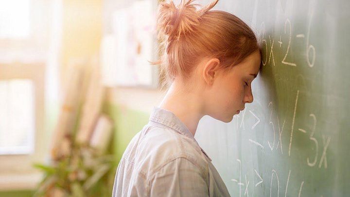 Elev der har hovedet mod tavlen i frustration